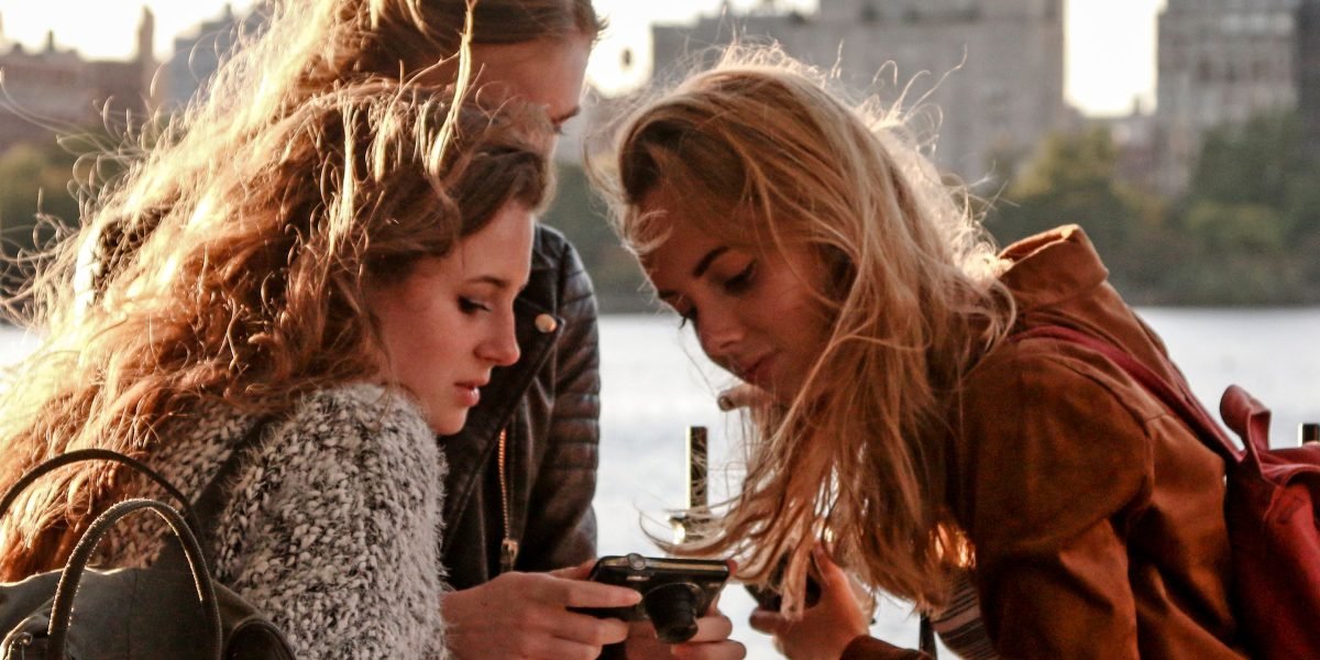Friends thoughtfully exchanging ideas, possibly about complex fictional worlds, with shared excitement.