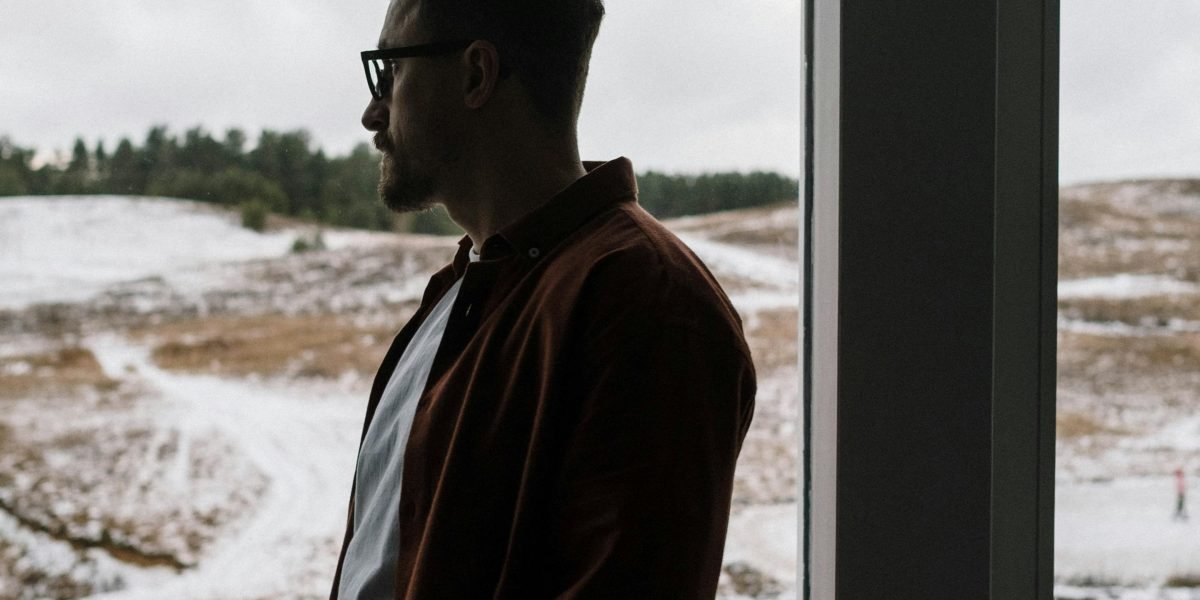A thoughtful individual pondering complex questions about identity and reality in a digital age.