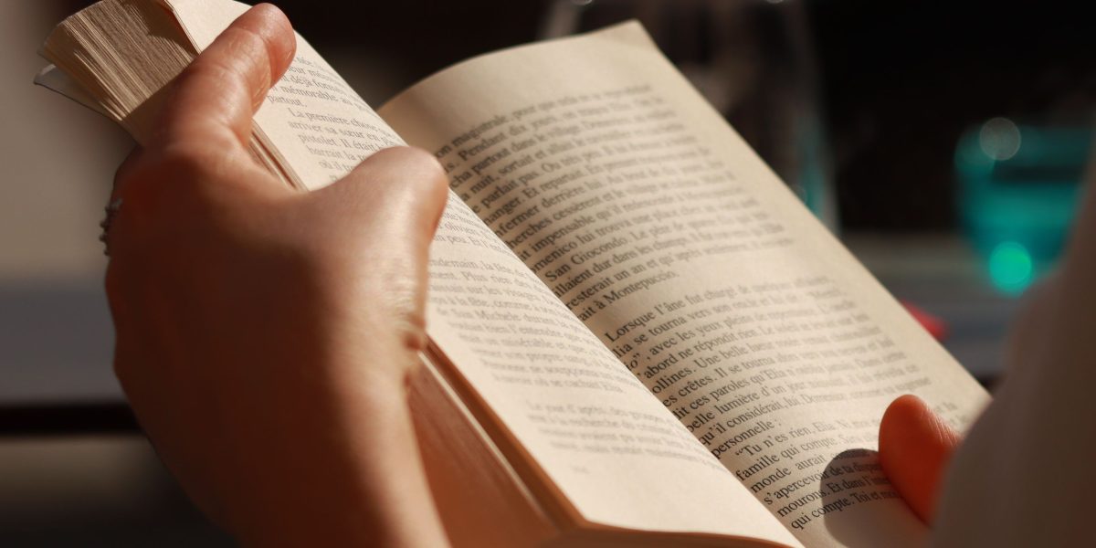 A person deeply engaged in reading a classic novel, reflecting the article's focus on timeless stories.